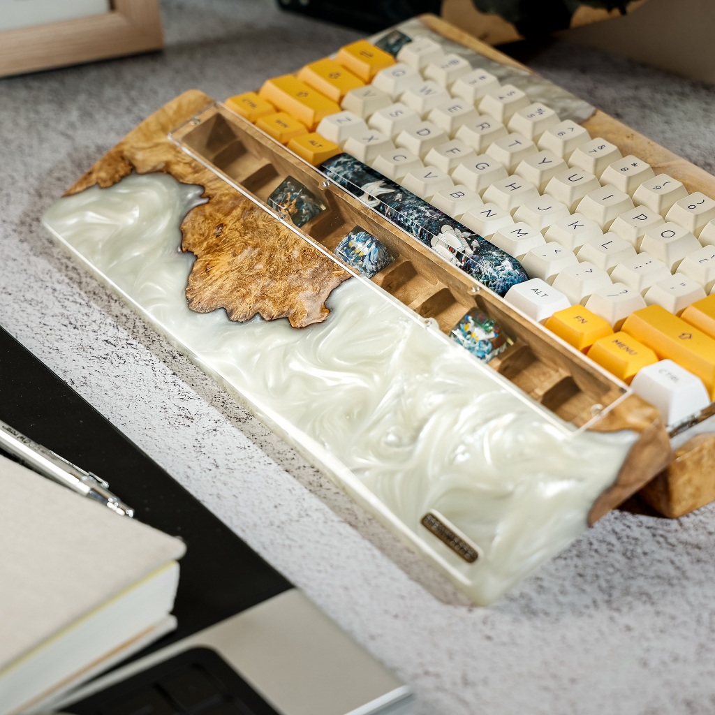 Hand's natural wood keyboard and resin have a keycap compartment