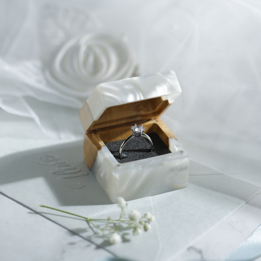 The engagement ring box is made of natural wood customized for couples